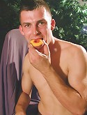 Thomas eats a peach while his uncut cock hangs out.