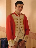 Marching band boy play his horn in front of the mirror